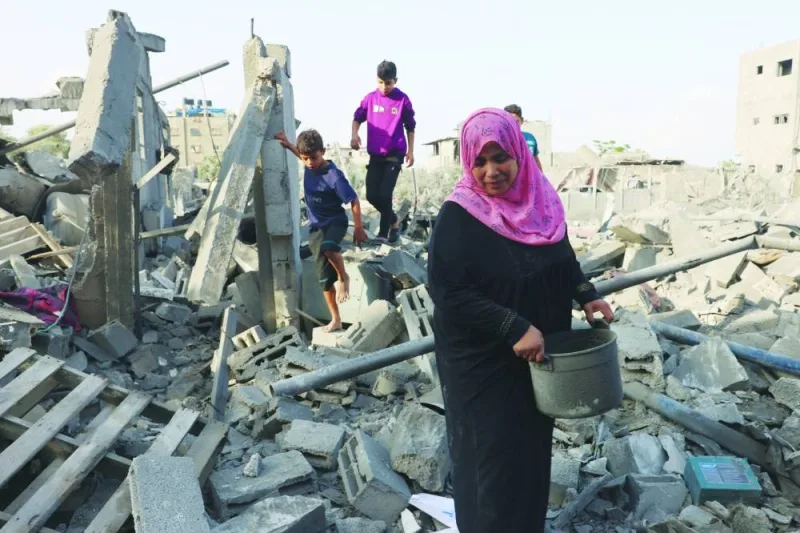 
Palestinians inspect the damage after overnight Israeli strikes on Rafah in the southern Gaza Strip, yesterday. 