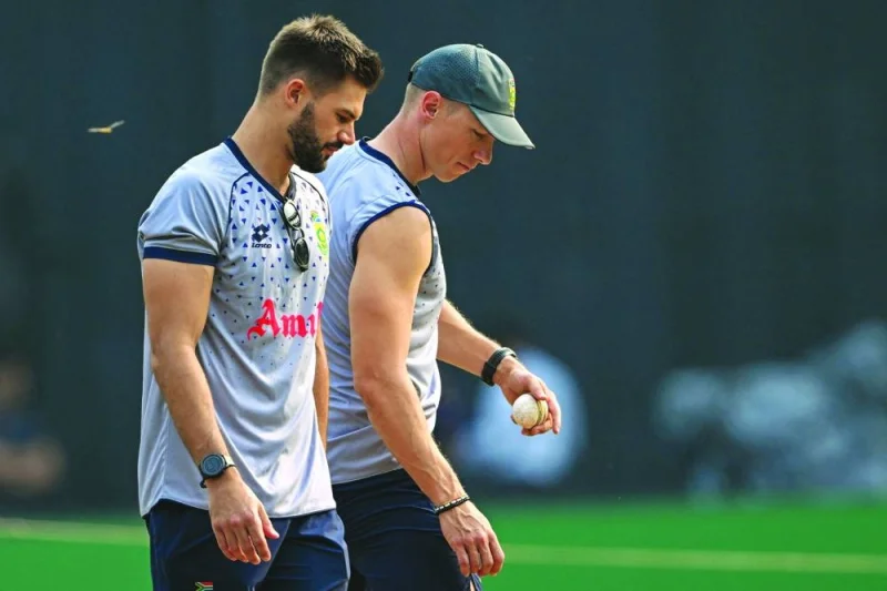 South Africa’s Aiden Markram (left) and Rassie van der Dussen inspect the pitch during a practice session on the eve of their 2023 ICC Men’s Cricket World Cup match against Bangladesh at the Wankhade Stadium in Mumbai on Monday. (AFP)