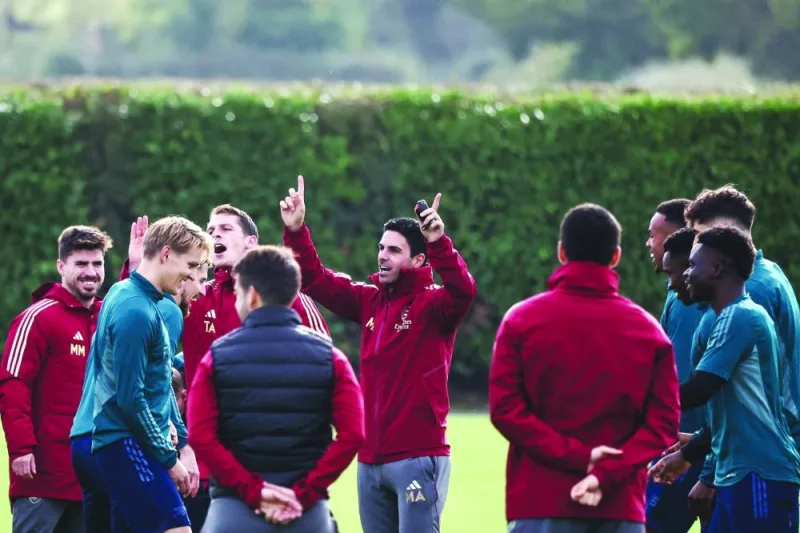 Arsenal’s manager Mikel Arteta (centre) reacts as he leads a team training session at London on Monday, ahead of their UEFA 
Champions League Group B match against Sevilla. (AFP)