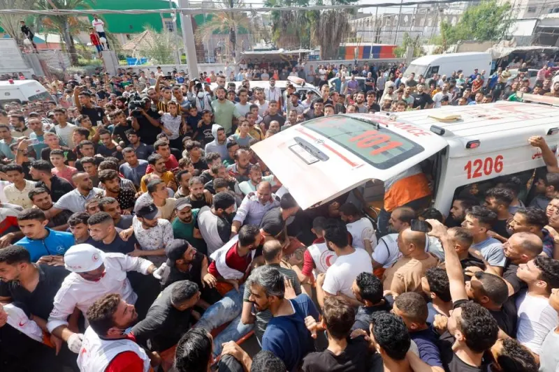 Palestinians gather around an ambulance following Israeli strikes in Khan Younis, in the southern Gaza Strip, on Tuesday. REUTERS