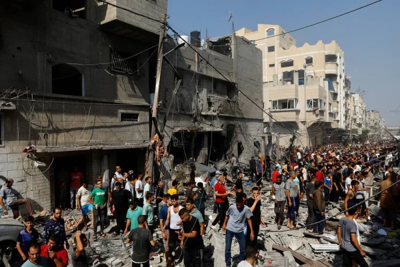 People gather at the site of an Israeli strike on a house, in Khan Younis, in the southern Gaza Strip, on Tuesday. REUTERS