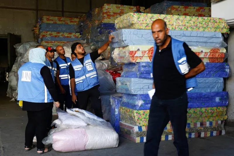 Workers sort aid to be distributed to Palestinians at a United Nations-run facility, in Khan Younis in the southern Gaza Strip, Thursday. REUTERS