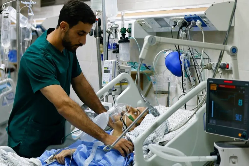 A medical worker assists a Palestinian, who was wounded in Israeli strikes, at the Intensive Care Unit (ICU) of Nasser hospital, as doctors say they are only able to accept critical cases that are in need of surgery, while the unit is filled up with victims of the ongoing conflict with Israel, in Khan Younis, in the southern Gaza Strip, Thursday. REUTERS