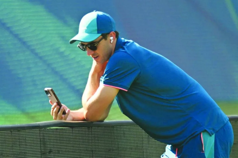 
Australia’s Pat Cummins uses his mobile phone during a practice session on the eve of their 2023 ICC Men’s Cricket World Cup match against New Zealand in Dharamsala. (AFP)  