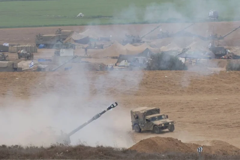 Israeli artillery unit fires from the Israeli side of the Israel Gaza border into Gaza, on Sunday. REUTERS