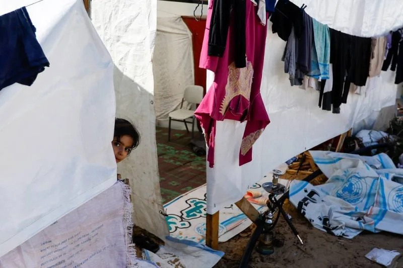 A child looks on as displaced Palestinians, who fled their houses amid Israeli strikes, take shelter at a tent camp at a United Nations-run centre, in Khan Younis in the southern Gaza Strip, on Monday. REUTERS
