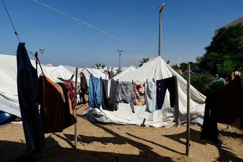 Clothes dry up under the sun as displaced Palestinians, who fled their houses amid Israeli strikes, take shelter at a tent camp at a United Nations-run centre, in Khan Younis in the southern Gaza Strip, on Monday. REUTERS