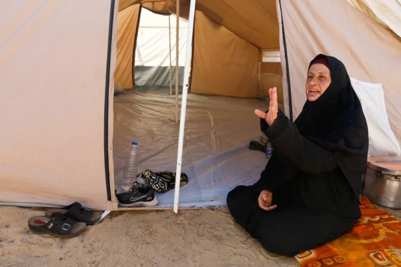 A woman gestures as displaced Palestinians, who fled their houses amid Israeli strikes, take shelter at a tent camp at a United Nations-run centre, in Khan Younis in the southern Gaza Strip, on Monday. REUTERS