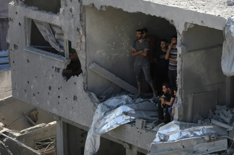 Palestinians observe as others search for casualties a day after Israeli strikes on houses in Jabalia refugee camp in the northern Gaza Strip, Wednesday. REUTERS