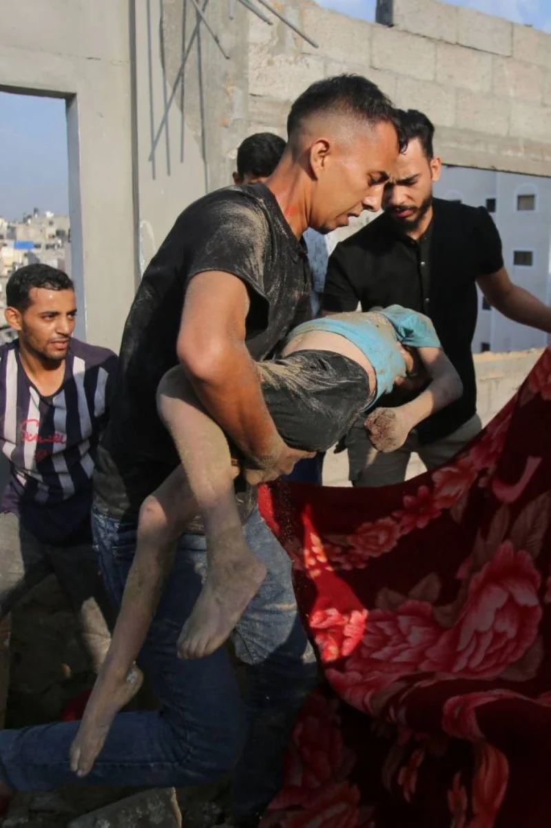 Palestinians carry the body of a victim in the aftermath of an Israeli strike in the Jabalia camp for Palestinian refugees in the Gaza Strip, on Wednesday. AFP