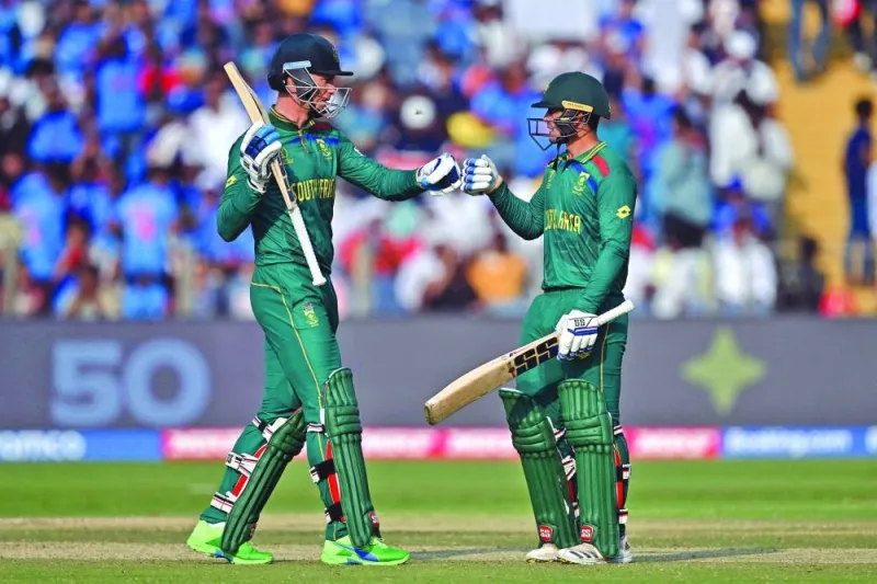 South Africa’s Rassie van der Dussen (left) celebrates with teammate Quinton de Kock during the ICC World Cup match against New Zealand at the Maharashtra Cricket Association Stadium in Pune on Wednesday. (AFP)