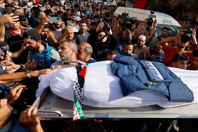 Mourners attend the funeral of Palestinian journalist Mohammed Abu Hattab, who was killed in an Israeli strike, in Khan Younis in the southern Gaza Strip, on Friday. REUTERS
