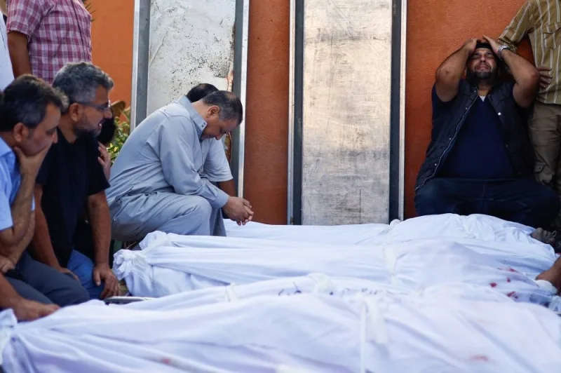 People react next to the bodies of Palestinians killed in Israeli strikes at a hospital, in Khan Younis in the southern Gaza Strip, on Friday. REUTERS