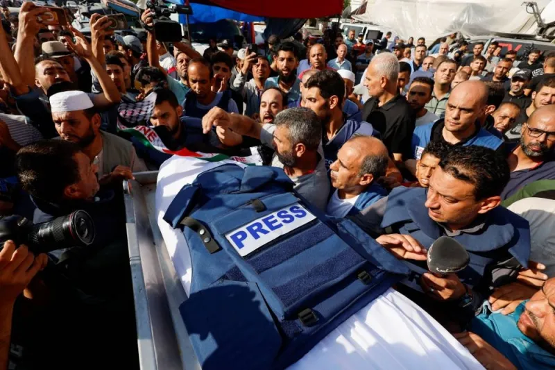 Mourners attend the funeral of Palestinian journalist Mohammed Abu Hattab, who was killed in an Israeli strike, in Khan Younis in the southern Gaza Strip, on Friday. REUTERS