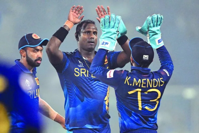 
Sri Lanka’s Angelo Mathews (centre) celebrates with teammates after taking the wicket of Bangladesh’s Najmul Shanto during the ICC World Cup match in New Delhi on Monday. (AFP) 