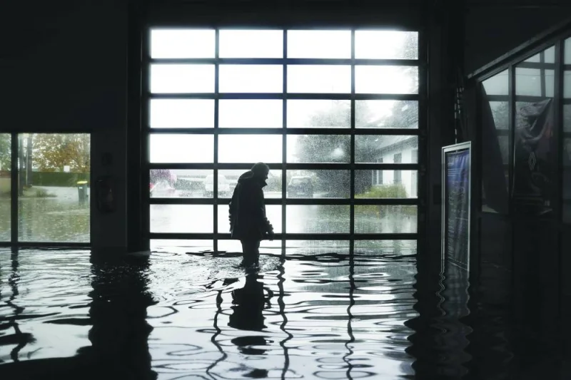 A man is seen in his flooded garage in Longfosse, northern France.