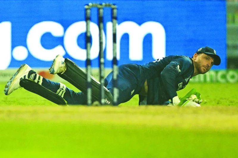 
England’s captain Jos Buttler dives to field the ball during the ICC World Cup match against Pakistan at the Eden Gardens in Kolkata on Saturday. (AFP)  