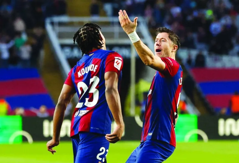 
Barcelona’s Robert Lewandowski (right) celebrates with Jules Kounde after scoring against Deportivo Alaves yesterday. (Reuters) 