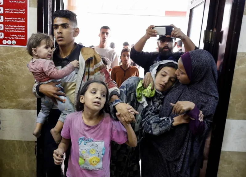 Palestinians react following Israeli strikes at a hospital in Khan Younis in the southern Gaza Strip, on Monday. REUTERS