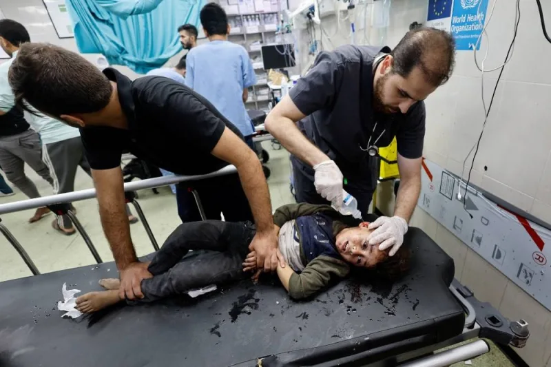 A medical worker assists a Palestinian child, wounded in an Israeli strike in Khan Younis in the southern Gaza Strip, on Monday. REUTERS
