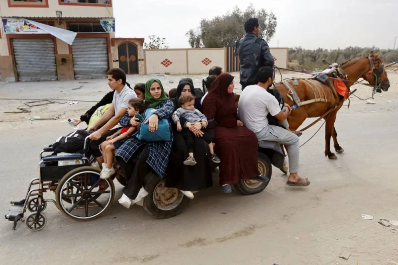 Palestinians fleeing north Gaza ride a horse-drawn cart as they move southward, as Israeli tanks roll deeper into the enclave in the central Gaza Strip, on Monday. REUTERS