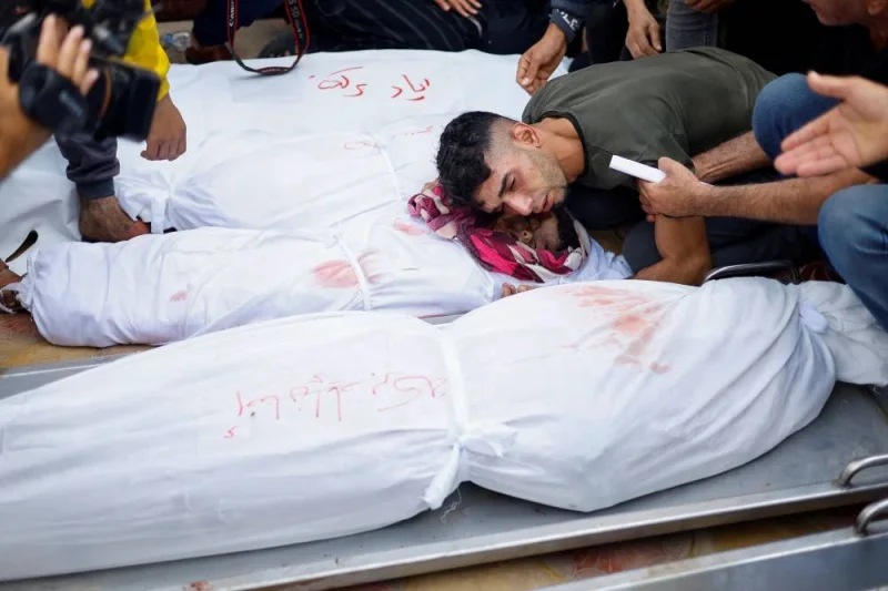 A man mourns near the body of a Palestinian child at a hospital, following Israeli strikes in Khan Younis in the southern Gaza Strip, on Monday. REUTERS
