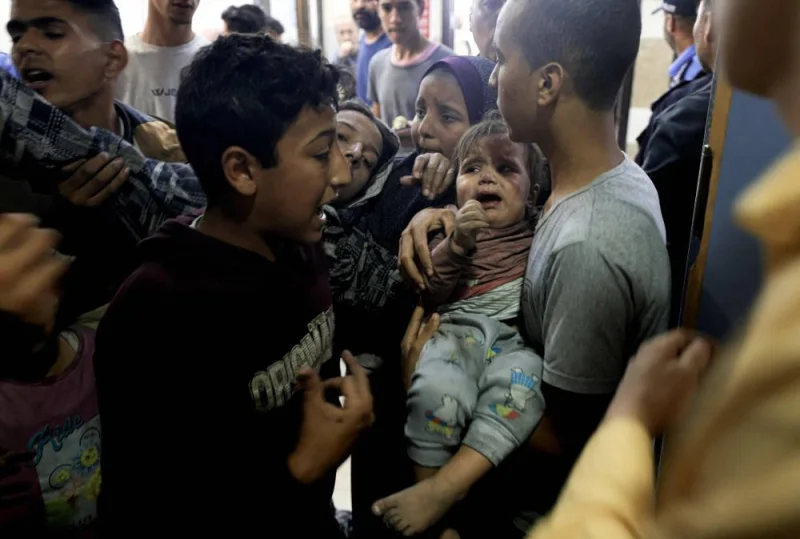 A wounded Palestinian child and other members of the Baraka family arrive at Nasser Hospital in Khan Yunis, following Israeli air strikes that hit their building in the southern Gaza Strip city on Monday. AFP
