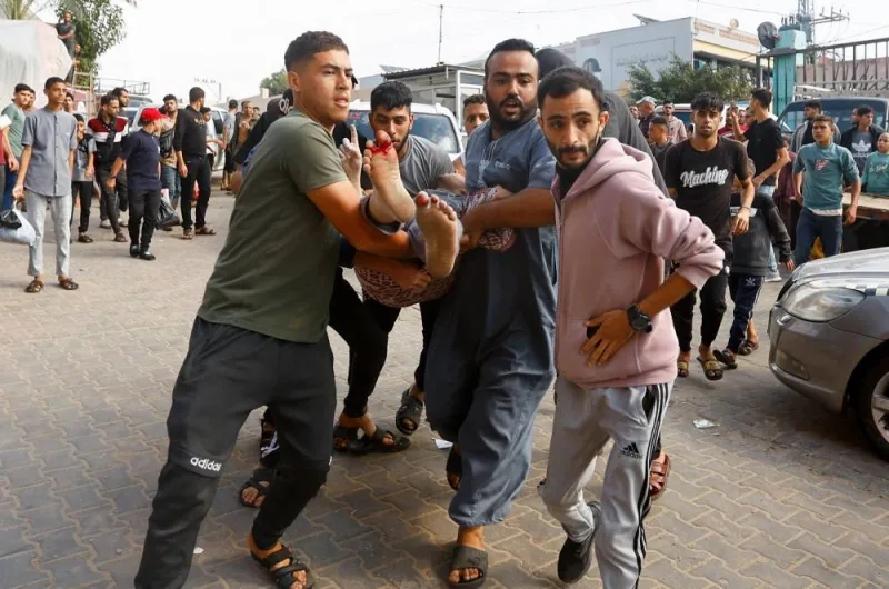 A Palestinian man wounded in an Israeli strike is rushed into Nasser hospital in Khan Younis in the southern Gaza Strip, on Tuesday. REUTERS