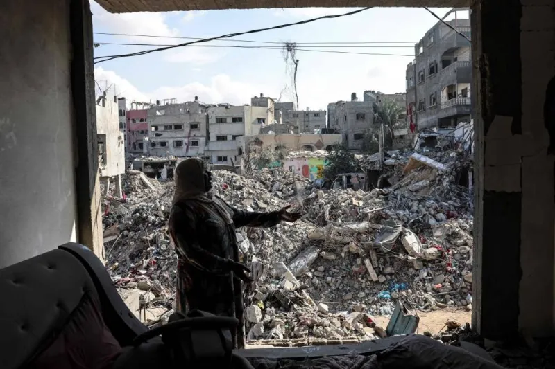 A Palestinian woman gestures as she explains how her home was destroyed duing the Israeli bombardment, in Bureij in the central of Gaza Strip, on Tuesday. AFP