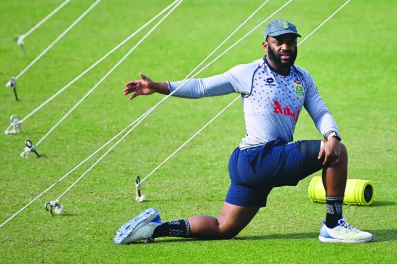 
South Africa’s captain Temba Bavuma stretches during a practice session at the Eden Garden Cricket Stadium in Kolkata ahead of their ICC World Cup semi-final against Australia. Right: Australia’s captain Pat Cummins rests during a practice session at the Eden Gardens in Kolkata. (AFP)  