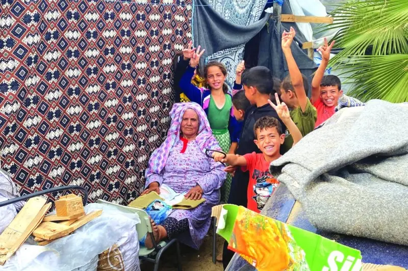 
Palestinian refugee Abla Awad, who witnessed 1948 war’s Nakba and has recently fled from north Gaza to south after Israel’s call, rests as she is 
surrounded by her grandchildren, at a tent camp where they take shelter, amid the ongoing conflict, in Khan Yunis in the southern Gaza Strip. 