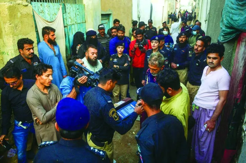 Police personnel test biometrics of Afghan refugees during a search operation to identify alleged illegal immigrants, on the outskirts of Karachi on November 17, 2023. More than 200,000 people have crossed from Pakistan into Afghanistan, Pakistani border officials said, the vast majority since an October ultimatum given to the 1.7 million Afghans Islamabad said were living illegally in the country. (Photo by Asif HASSAN / AFP)