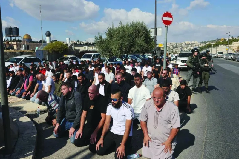 
Palestinians take part in Friday Noon prayers in East Jerusalem’s 
neighbourhood of Ras Al-Amud, yesterday, following age restriction by Israeli security to above 50-year-olds for worshippers wanting to access the Al-Aqsa Mosque compound. 
