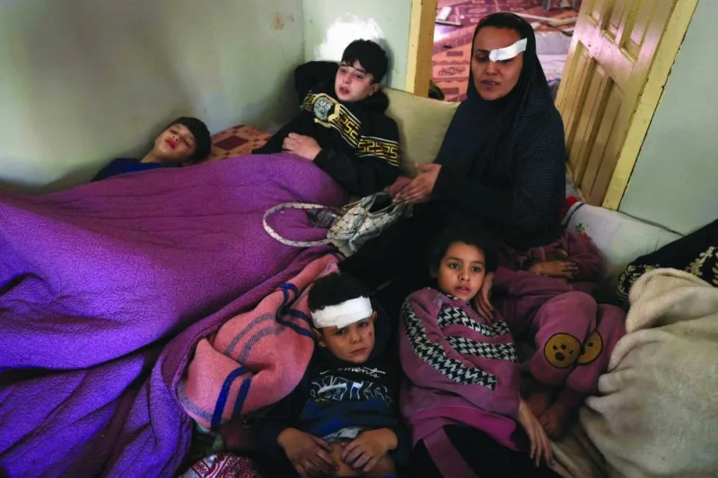 
Members of the Palestinian al-Rifi family who survived an Israeli 
bombardment, rest at a house after receiving treatment at a nearby hospital, yesterday, in Deir al-Balah in the centre of the Gaza Strip. 