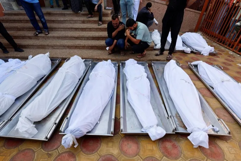 People react next to bodies of Palestinians who were killed in an Israeli strike, at the morgue of Nasser hospital, in Khan Younis in the southern Gaza Strip, on November 7. REUTERS