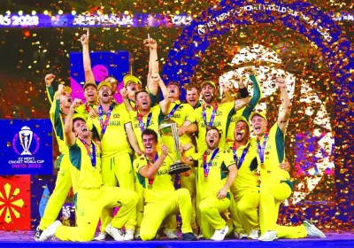 Australia players celebrate with the trophy after winning the ICC World Cup in Ahmedabad Sunday. Reuters