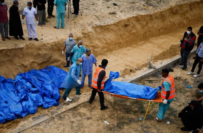 The  bodies of Palestinians killed in Israeli strikes and fire are buried in a mass grave, after they were transported from Al Shifa hospital in Gaza City for burial, in Khan Younis in the southern Gaza Strip on Wednesday. REUTERS