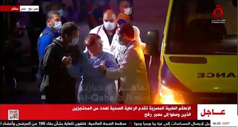 Released hostages disembark from an ambulance, in Egypt Friday. Al Qahera News/Reuters TV via REUTERS.