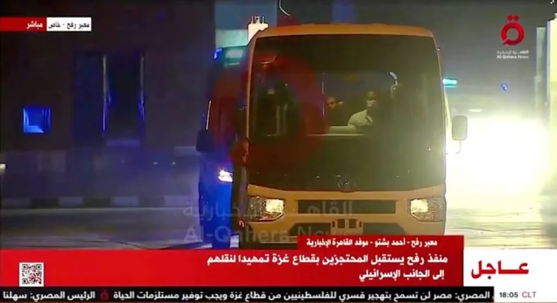 A convoy of vehicles carrying hostages arrives through the border crossing with Gaza, amid a hostages-prisoners swap deal between Hamas and Israel, in Egypt Friday. Al Qahera News/Reuters TV via REUTERS.