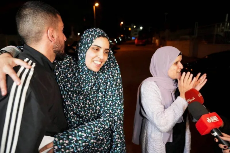 Released Palestinian prisoner Marah Bkeer reacts with a family near her house after hostages-prisoners swap deal between Hamas and Israel,in Jerusalem on Friday. REUTERS