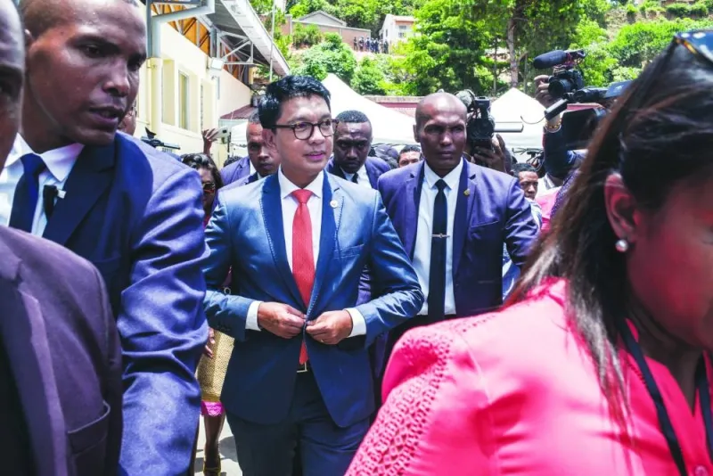 
President of Madagascar Andry Rajoelina buttons his blazer as he 
attends the announcement of the provisional results in the first round of Madagascar’s presidential elections in Antananarivo, yesterday. 