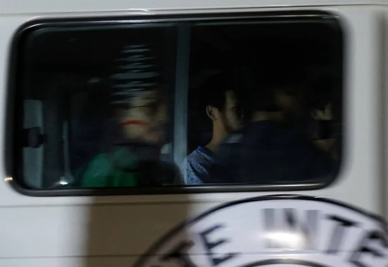A Red Cross vehicle, as part of a convoy believed to be carrying hostages arrives at the Rafah border, amid a hostages-prisoners swap deal between Hamas and Israel, in southern Gaza Strip Saturday night. REUTERS