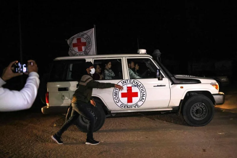 A Red Cross vehicle, as part of a convoy believed to be carrying hostages arrives at the Rafah border, amid a hostages-prisoners swap deal between Hamas and Israel, in southern Gaza Strip Saturday night. REUTERS