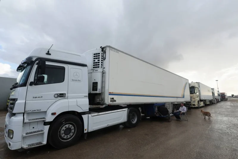 Trucks with humanitarian aid wait on the Egyptian side of the Rafah border crossing between Egypt and the Gaza Strip, during a temporary truce between Hamas and Israel, in Rafah, Egypt, Monday. REUTERS