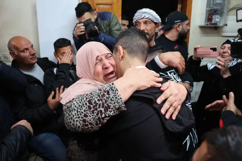 Ahmad Salaima is welcomed by relatives upon his arrival at his home in Israeli-annexed east Jerusalem on Tuesday, after 30 Palestinian detainees were released under an extended truce deal. AFP