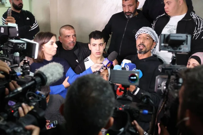 Ahmad Salaima speaks to the press with his father upon his arrival at his home in Israeli-annexed east Jerusalem on Tuesday, after 30 Palestinian detainees were released under an extended truce deal. AFP