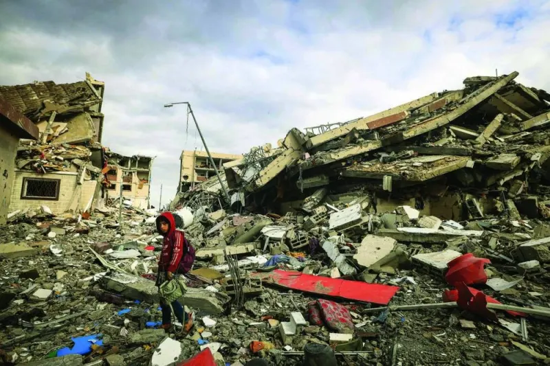 Palestinians inspect the destruction caused by Israeli strikes in Wadi Gaza, in the central Gaza Strip, yesterday.