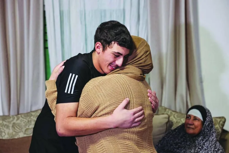 Palestinian Mohamed Abu al-Humus, former prisoner released from the Israeli jail in exchange for hostages freed by Hamas in Gaza, hugs his mother upon return to his home in east Jerusalem, yesterday.