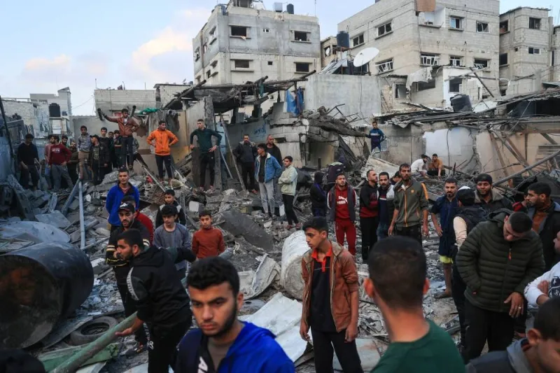 Palestinians watch as medics look for survivors in the rubble of a building following Israeli bombardment in Rafah in the southern Gaza Strip, on Friday. AFP