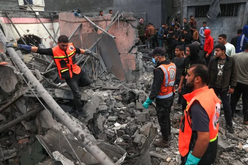 Palestinian medics search for survivors in the rubble of a building following Israeli bombardment in Rafah in the southern Gaza Strip, on Friday. AFP